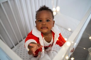 high angle baby standing in crib