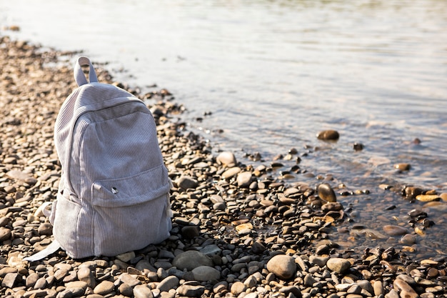 High angle backpack beside seaside