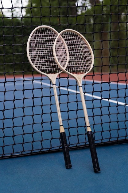 Free photo high angle badminton rackets on field