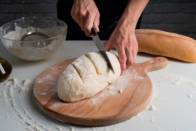 High angle baker slicing dough