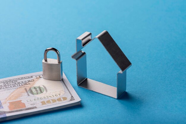 Free photo high angle of banknotes with lock and house
