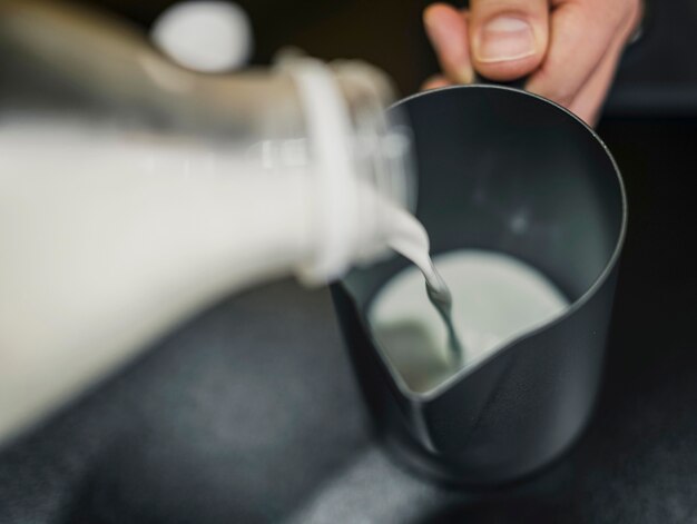 High angle of barista pouring milk