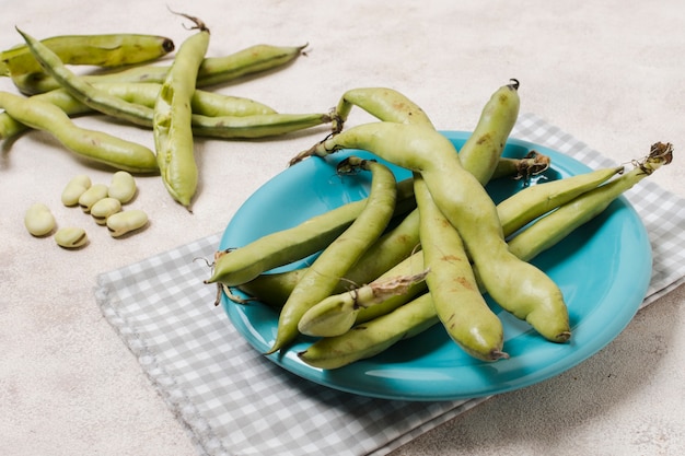 High angle of beans on plate with garlic