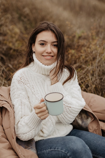 Free photo high angle beautiful woman drinking tea