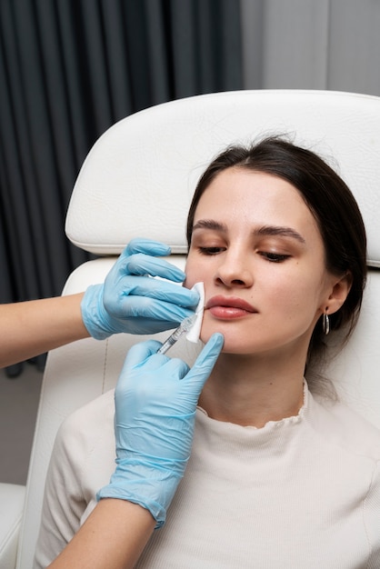 High angle beautiful woman getting lip fillers