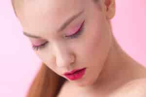 Free photo high angle beautiful woman wearing pink makeup