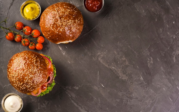 High angle beef burgers with cherry tomatoes