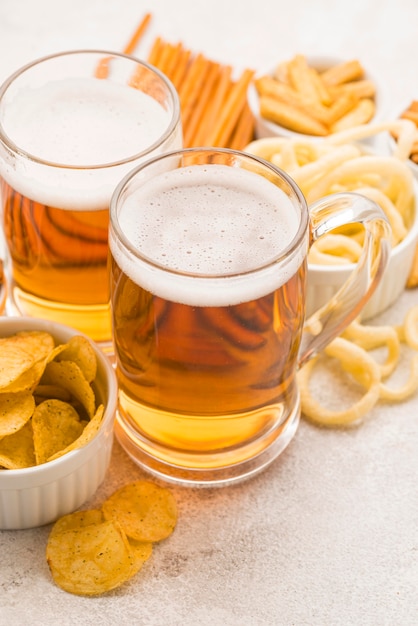 High angle beer mugs and snacks