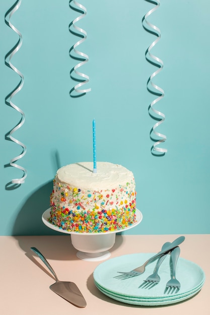 High angle birthday cake and cutlery