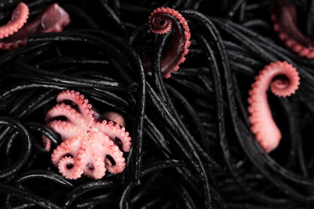 High angle of black pasta with squid
