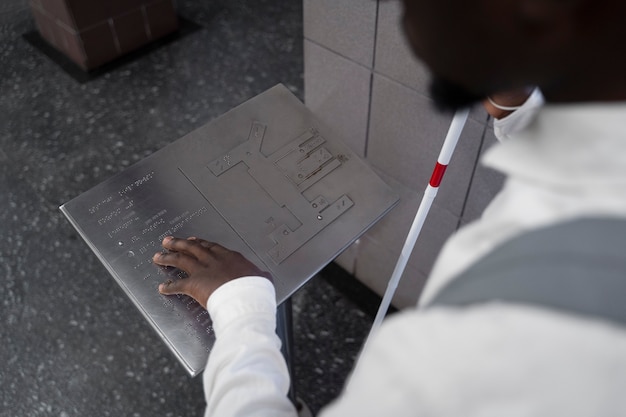 High angle blind man using braille alphabet