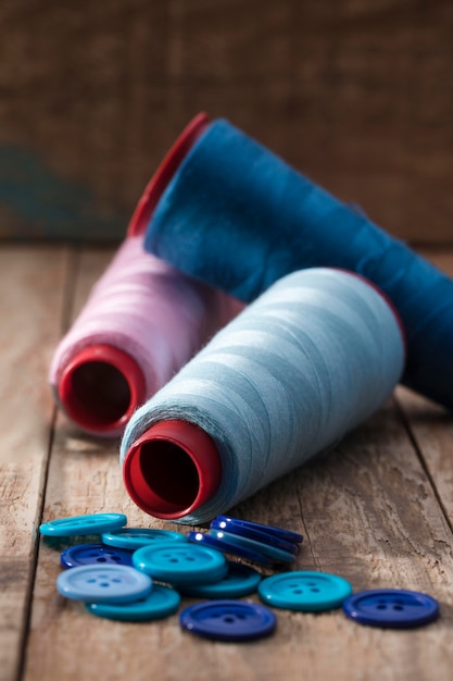 High angle of blue buttons with thread reels