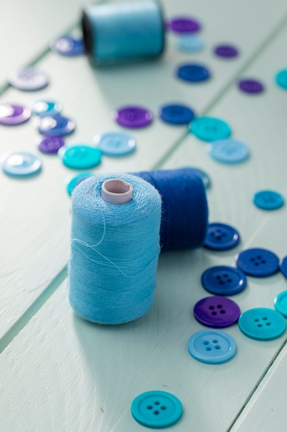 Free photo high angle of blue buttons with thread