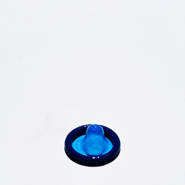 Free photo high angle blue condom on white background