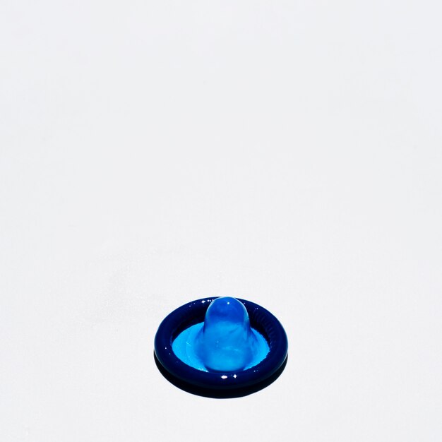 High angle blue condom on white background