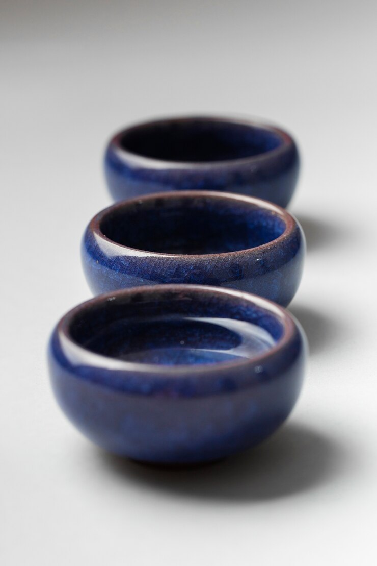 Free Photo high angle blue cups with sake drink arrangement