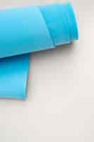 Free photo high angle blue yoga mat