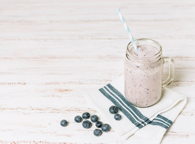 High angle blueberries smoothie on cloth with copy space