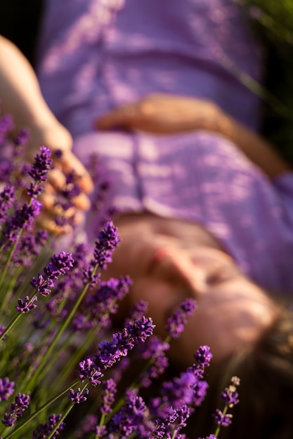 High angle blurry woman laying on lavender
