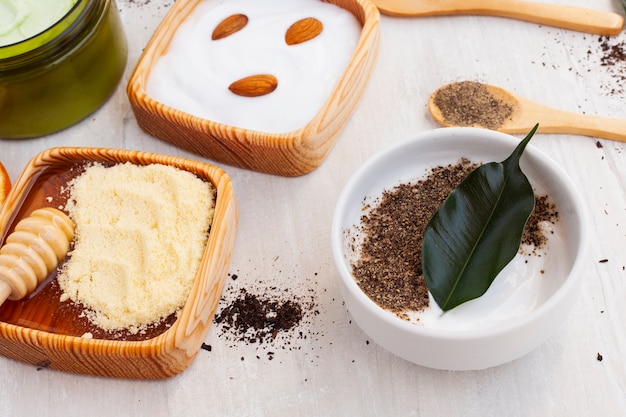 High angle of body butter and almonds on plain background