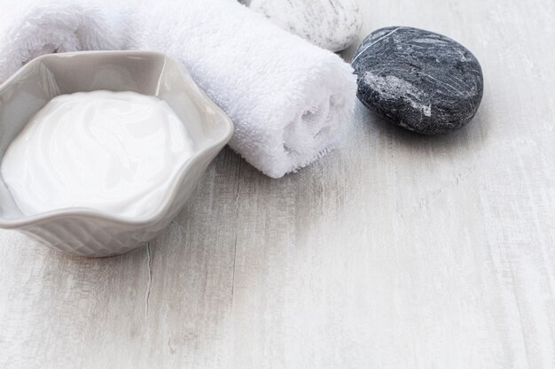 High angle of body butter and cloth on wooden table