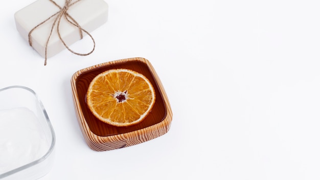 High angle of body butter and soap on white background