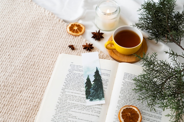 Free photo high angle bookmark and tea cup