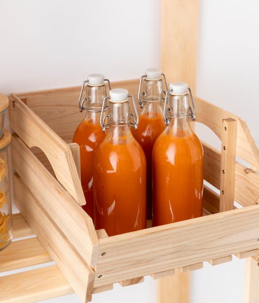 Free photo high angle bottles in wooden box