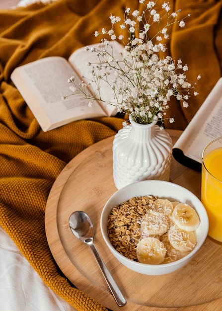 Free photo high angle bowl with cereal and banana slices