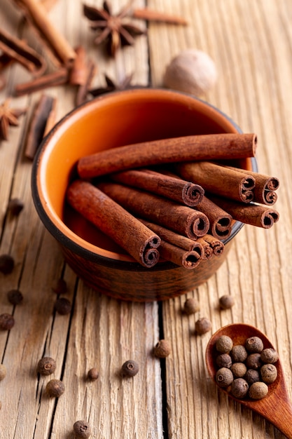 High angle of bowl with cinnamon sticks and nutmeg