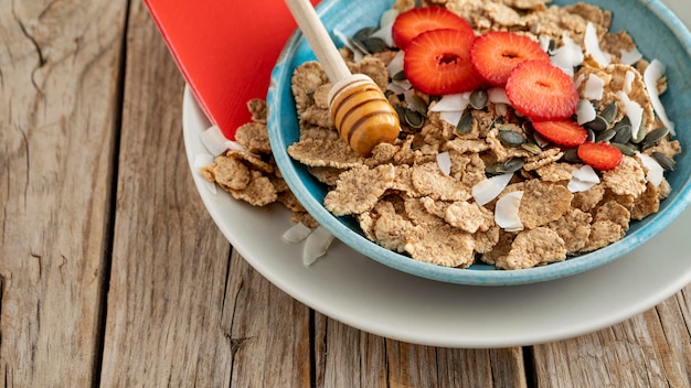 Free photo high angle of bowl with fruits and breakfast cereals