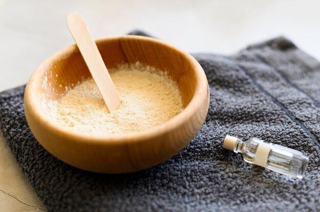 High angle of bowl with powder and essential oil