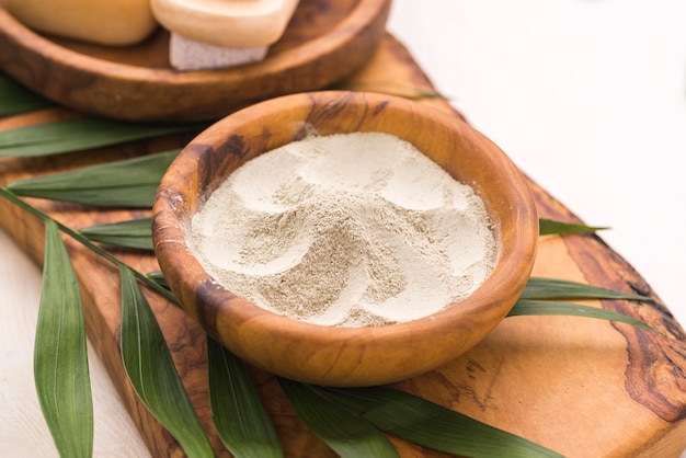 Free photo high angle of bowl with powder and leaves