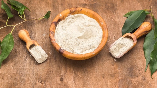 Free photo high angle of bowl with powder and two scoops