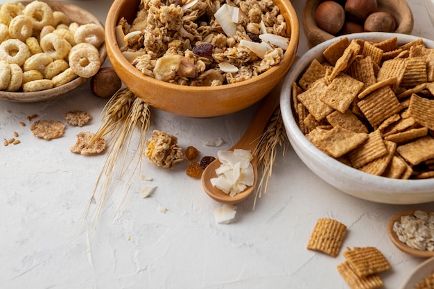 High angle of bowls with assortment of breakfast cereals