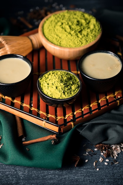 Free photo high angle bowls with green tea powder and tea drink