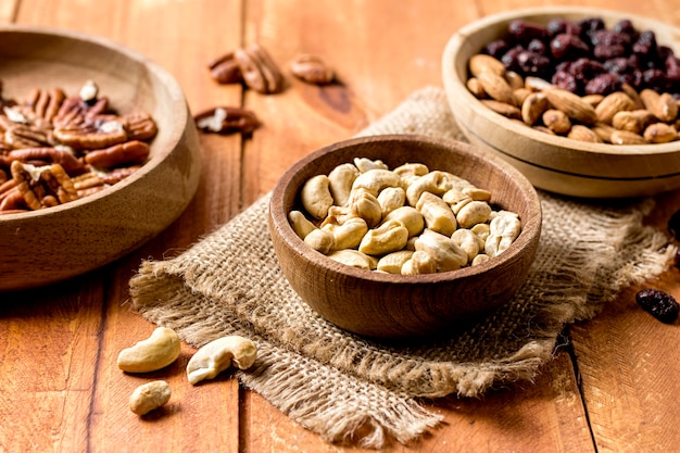 High angle of bowls with peanuts and walnuts