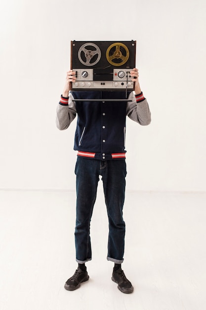 Free photo high angle boy holding cassette