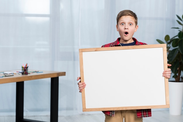 High angle boy holding frame