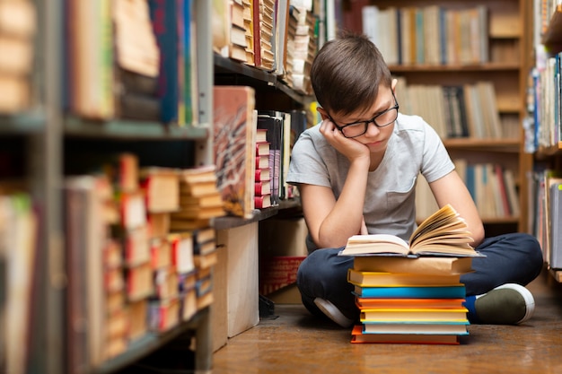 High angle boy at library reading