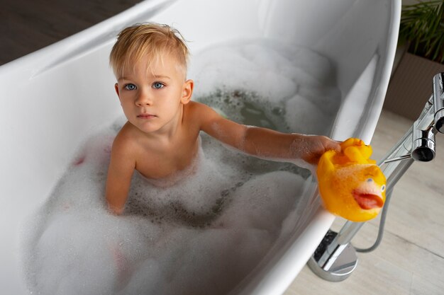 High angle boy playing in bathtub