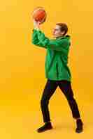 Free photo high angle boy playing with basketball ball