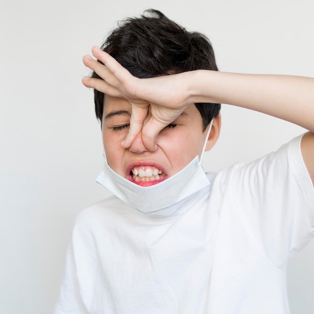 Free photo high angle boy sneezing