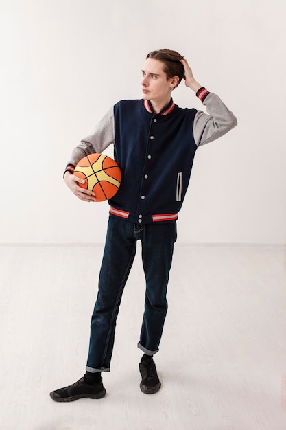 Free photo high angle boy with basketball ball