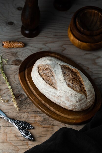 High angle of bread on chopper with wooden table