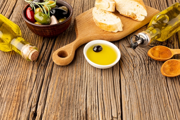 High angle bread olives mix and oil bottles