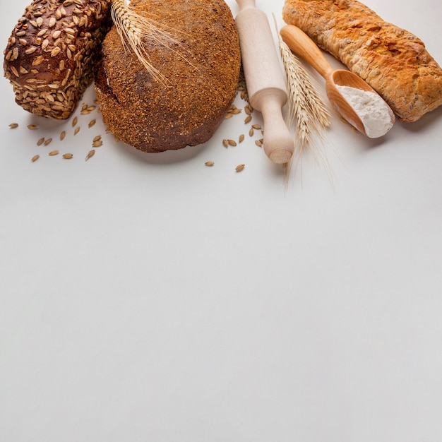 Free photo high angle of bread and rolling pin