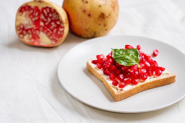 High angle bread with butter and pomegranate seeds