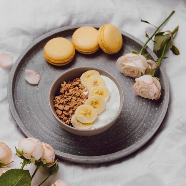High angle of breakfast bowl with cereal and macarons
