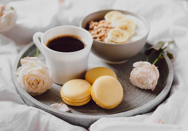 High angle of breakfast bowl with coffee and macarons